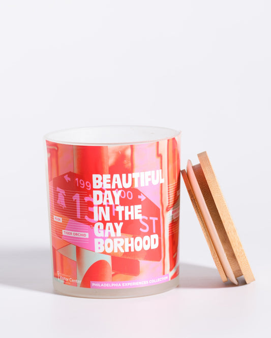 Color & Flame Handmade Beautiful Day in the Gayborhood Philadelphia Experiences candle shown open with its bamboo lid beside the jar.