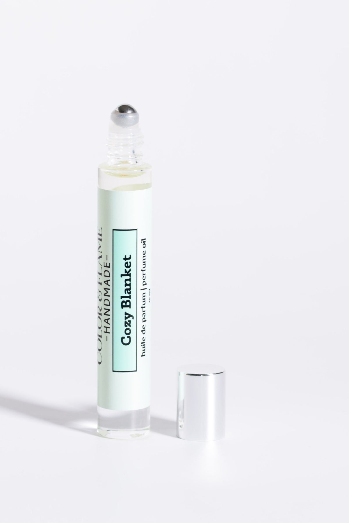 Color & Flame Handmade Cozy Blanket 10 ml perfume oil with cap removed to show the rollerball.