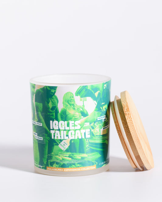 Color & Flame Handmade Iggles Tailgate Philadelphia Experiences candle shown open with its bamboo lid beside the jar.