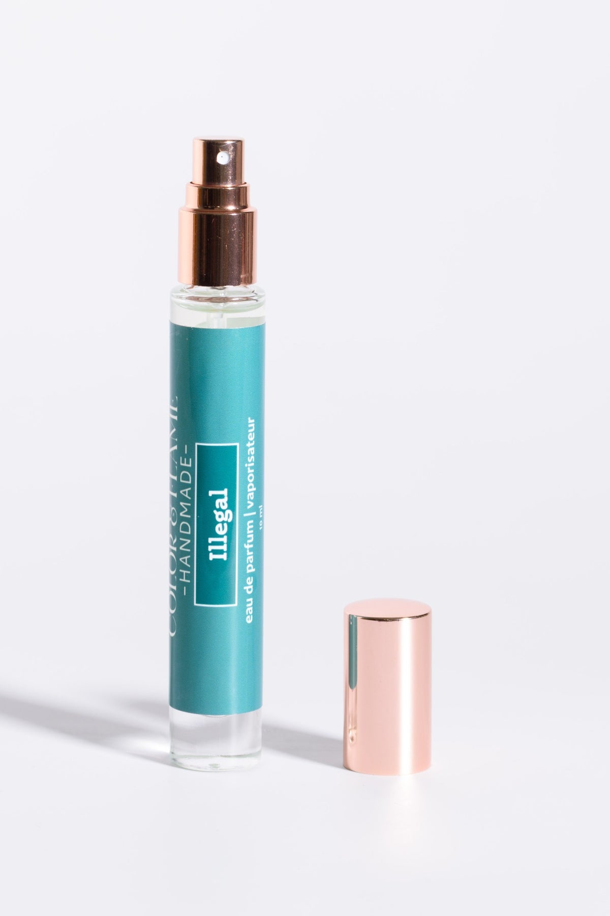 Color & Flame Handmade Illegal 10 ml perfume spray with cap removed to show the atomizer.