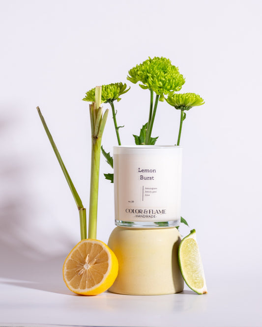 Color & Flame Handmade Lemon Burst candle styled with lemon, lime, lemongrass, and fresh green florals.