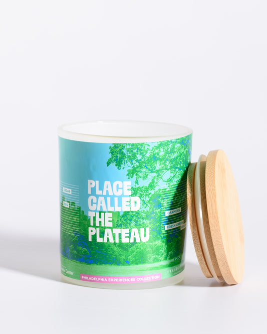Color & Flame Handmade Place Called the Plateau Philadelphia Experiences candle shown open with its bamboo lid beside the jar.