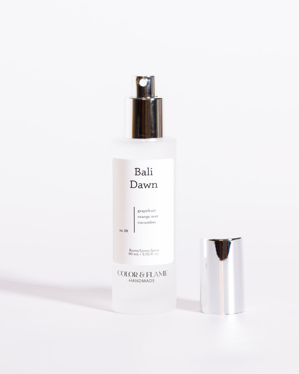 Color & Flame Handmade Bali Dawn room and linen spray bottle with cap removed to show the atomizer.
