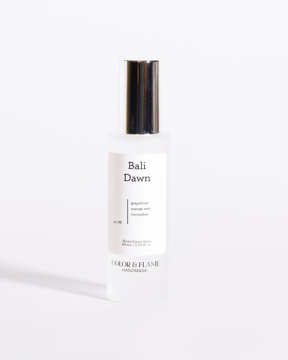 Color & Flame Handmade Bali Dawn room and linen spray bottle with its silver cap attached.
