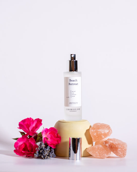 Color & Flame Handmade Beach Retreat room and linen spray styled with pink roses, lavender, and pink salt crystals.

