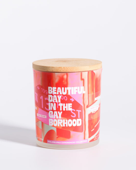 Color & Flame Handmade Beautiful Day in the Gayborhood Philadelphia Experiences candle with its bamboo lid attached.
