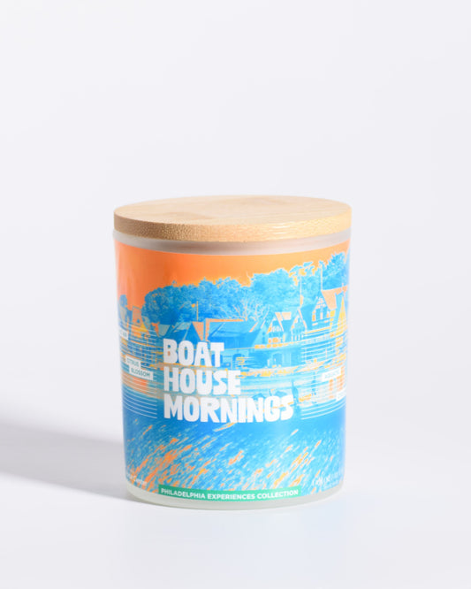 Color & Flame Handmade Boat House Mornings Philadelphia Experiences candle with its bamboo lid attached.
