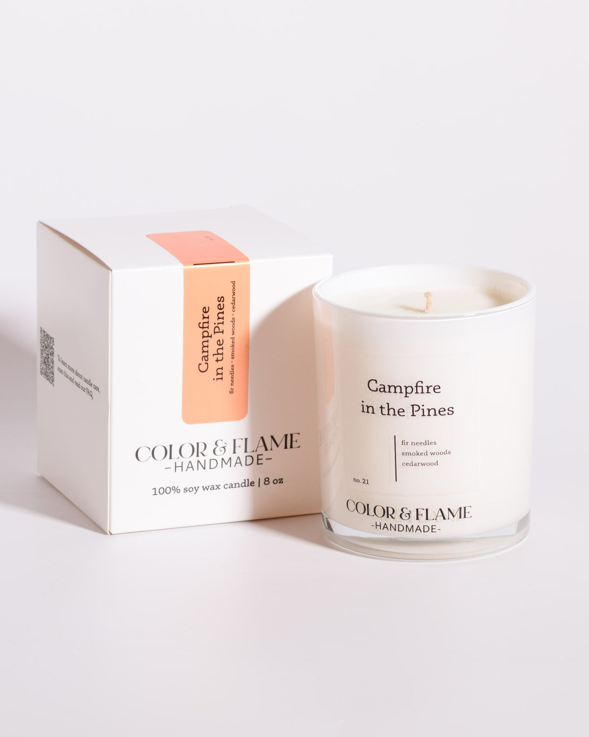 Color & Flame Handmade Campfire in the Pines Core Collection candle displayed beside its white box.
