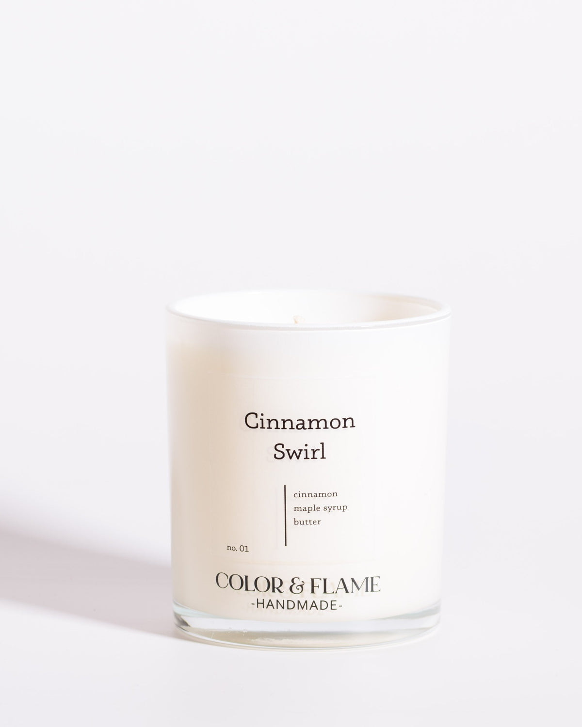 Color & Flame Handmade Cinnamon Swirl Core Collection candle in a white glass jar.
