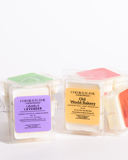 Assorted Color & Flame Handmade soy wax melts in clear clamshell packaging.