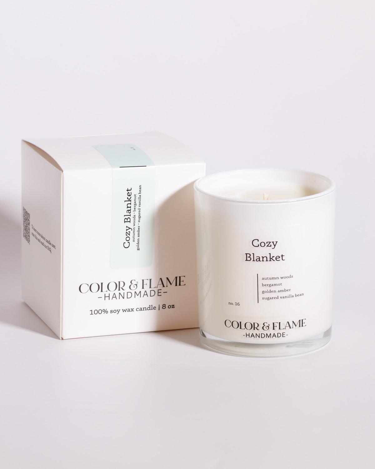 Color & Flame Handmade Cozy Blanket Core Collection candle displayed beside its white box.
