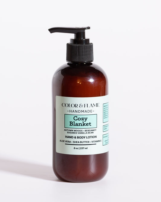 Color & Flame Handmade Cozy Blanket hand and body lotion in an amber pump bottle.
