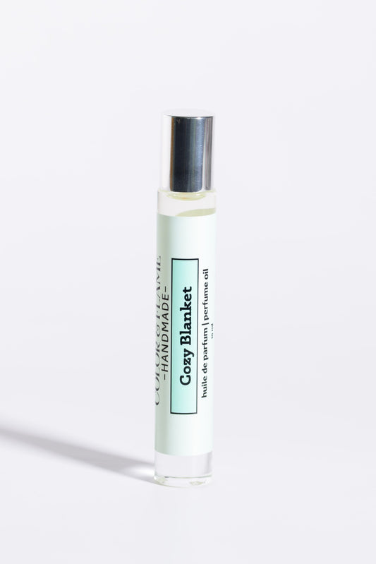 Color & Flame Handmade Cozy Blanket 10 ml roll-on perfume oil with its silver cap attached.
