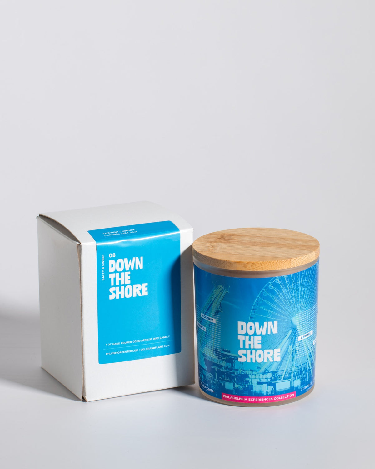 Color & Flame Handmade Down the Shore Philadelphia Experiences candle displayed beside its white box.
