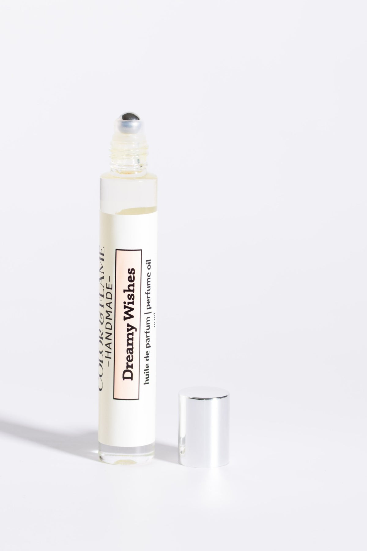Color & Flame Handmade Dreamy Wishes 10 ml perfume oil with cap removed to show the rollerball.

