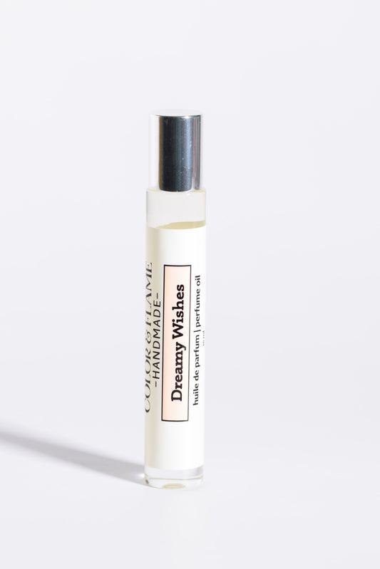 Color & Flame Handmade Dreamy Wishes 10 ml roll-on perfume oil with its silver cap attached.
