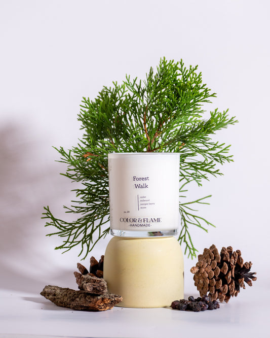 Color & Flame Handmade Dreamy Wishes candle styled with starfruit and pink, green, and white flowers.

