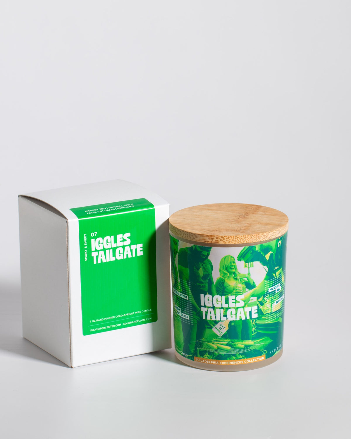 Color & Flame Handmade Iggles Tailgate Philadelphia Experiences candle displayed beside its white box.
