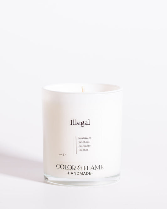 Color & Flame Handmade Illegal Core Collection candle in a white glass jar.
