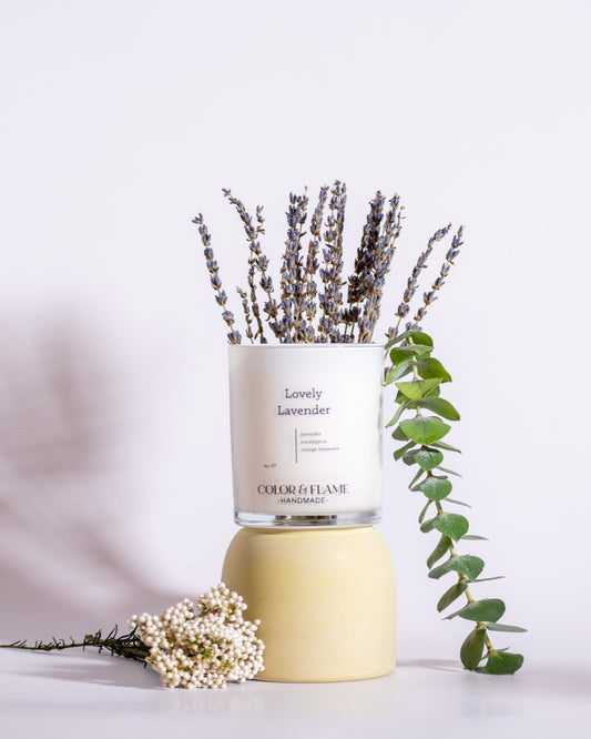 Color & Flame Handmade Lovely Lavender candle styled with lavender, eucalyptus, and delicate white flowers.
