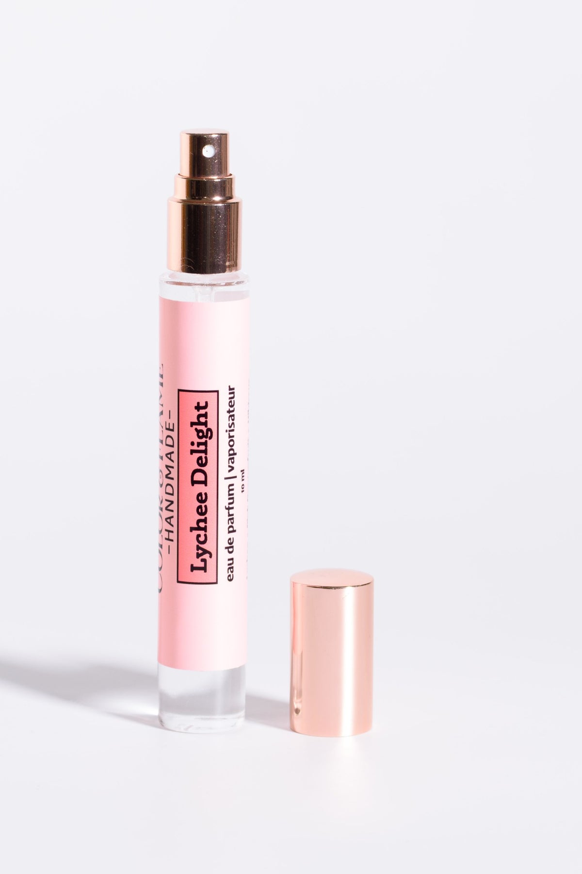 Color & Flame Handmade Lychee Delight 10 ml perfume spray with cap removed to show the atomizer.

