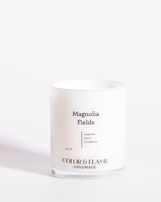 Color & Flame Handmade Magnolia Fields Core Collection candle in a white glass jar.
