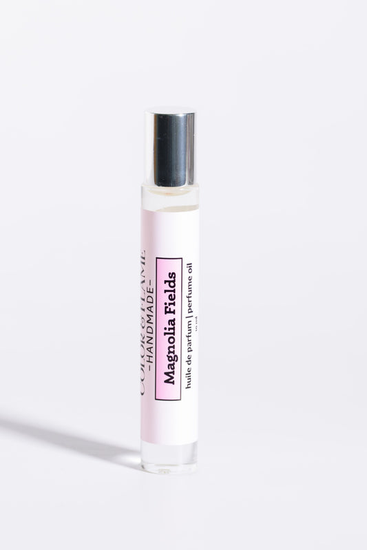 Color & Flame Handmade Magnolia Fields 10 ml roll-on perfume oil with its silver cap attached.
