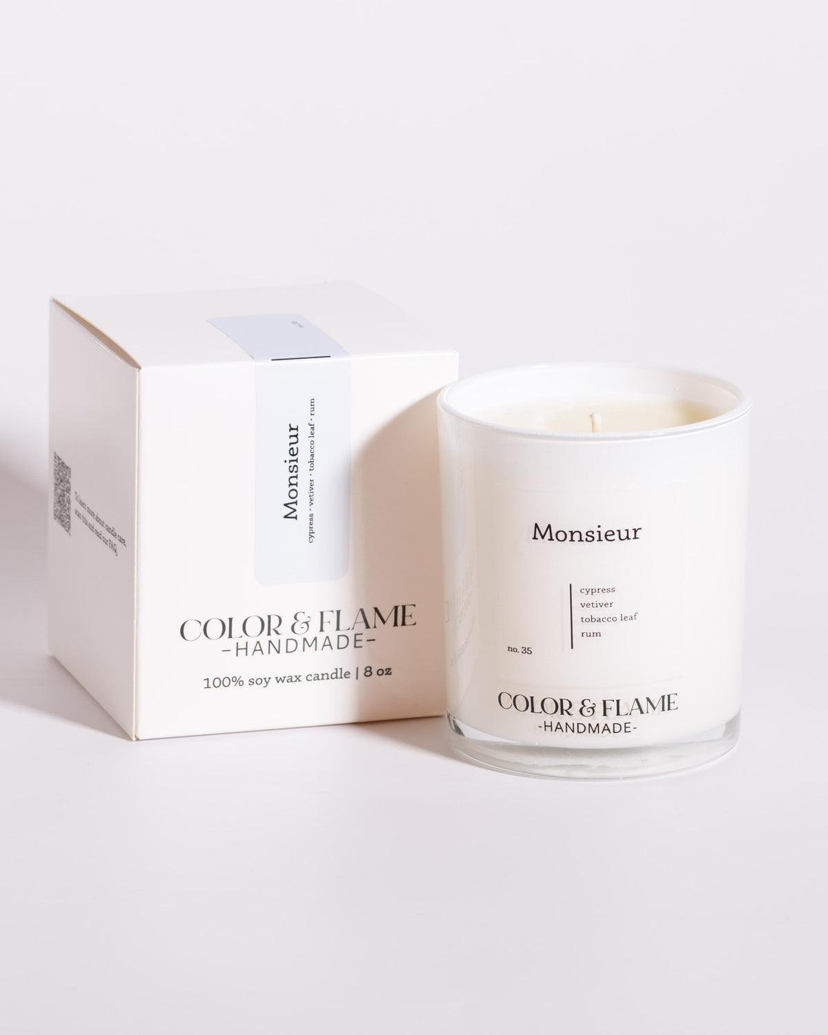 Color & Flame Handmade Monsieur Core Collection candle displayed beside its white box.
