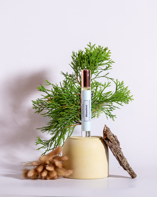 Color & Flame Handmade Monsieur perfume spray styled with evergreen branches, bark, and soft dried botanicals.
