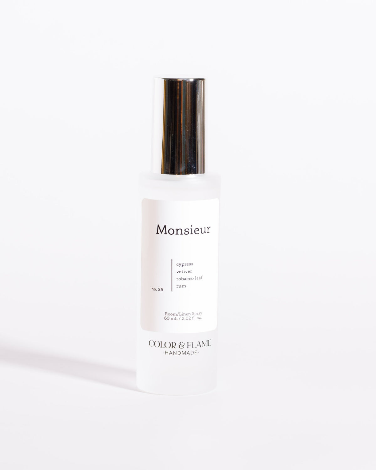 Color & Flame Handmade Monsieur room and linen spray bottle with its silver cap attached.
