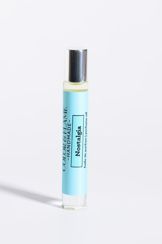Color & Flame Handmade Nostalgia 10 ml roll-on perfume oil with its silver cap attached.
