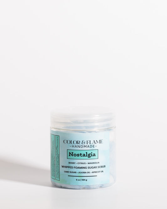 Color & Flame Handmade Nostalgia whipped foaming sugar scrub in a clear jar with a blue label.
