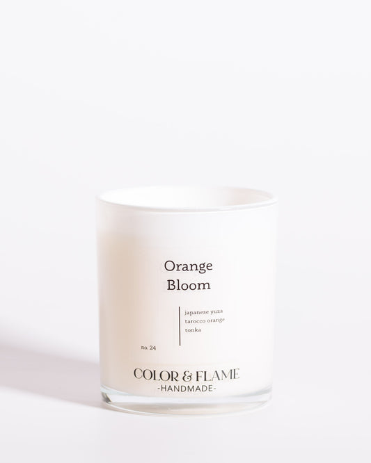 Color & Flame Handmade Orange Bloom Core Collection candle in a white glass jar.
