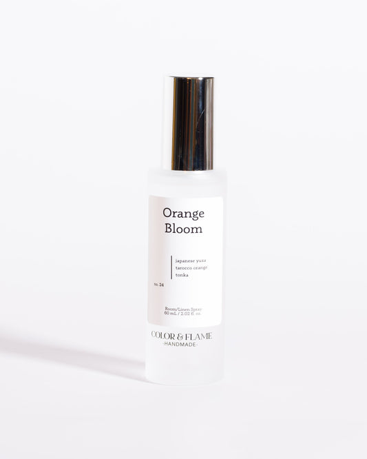 Color & Flame Handmade Orange Bloom room and linen spray bottle with its silver cap attached.
