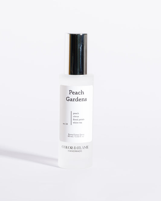 Color & Flame Handmade Peach Gardens room and linen spray bottle with its silver cap attached.
