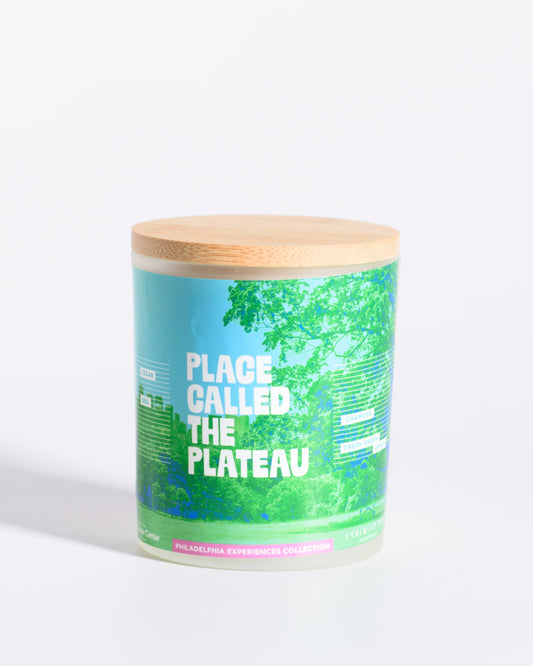 Color & Flame Handmade Place Called the Plateau Philadelphia Experiences candle with its bamboo lid attached.
