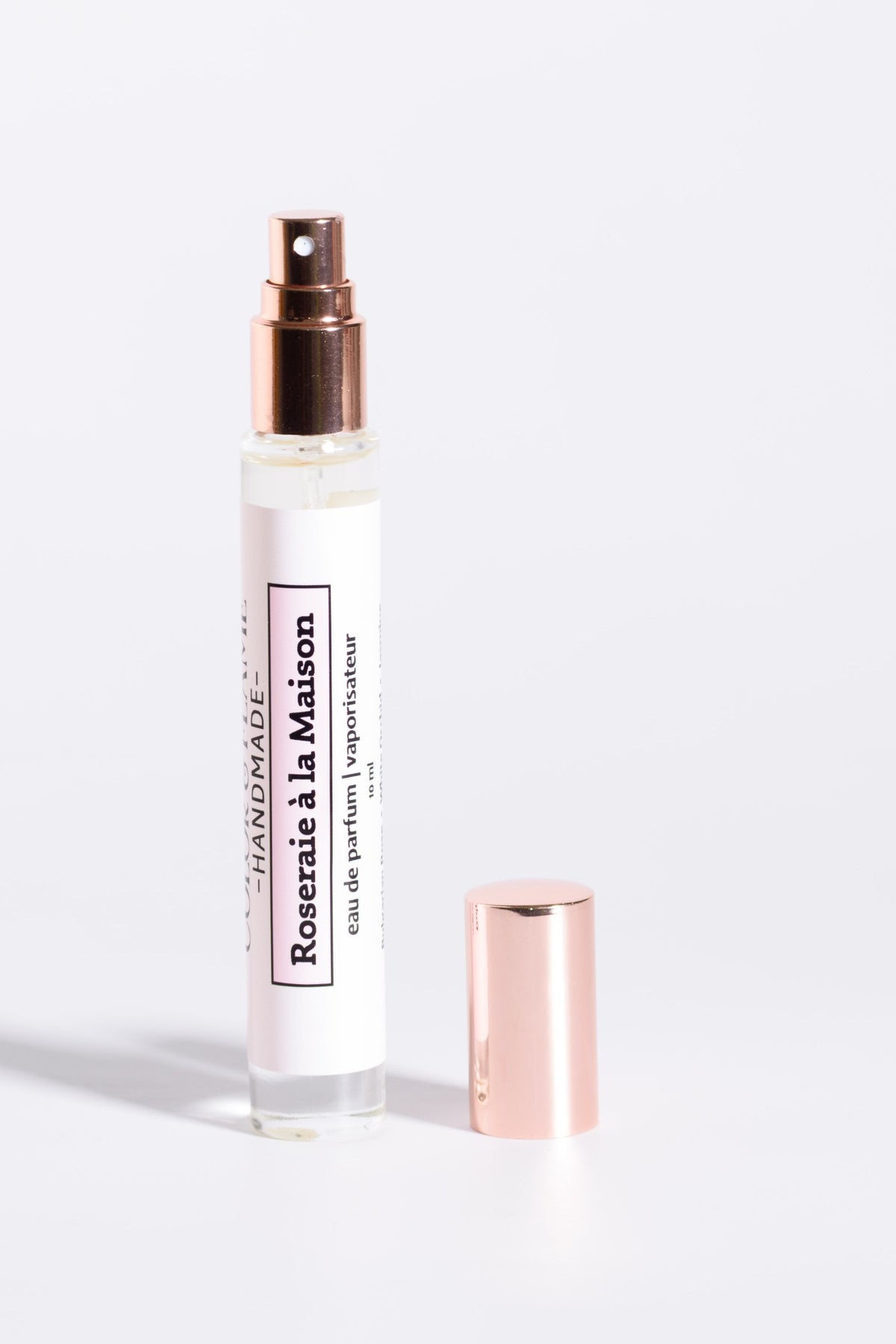 Color & Flame Handmade Roseraie à la Maison 10 ml perfume spray with cap removed to show the atomizer.

