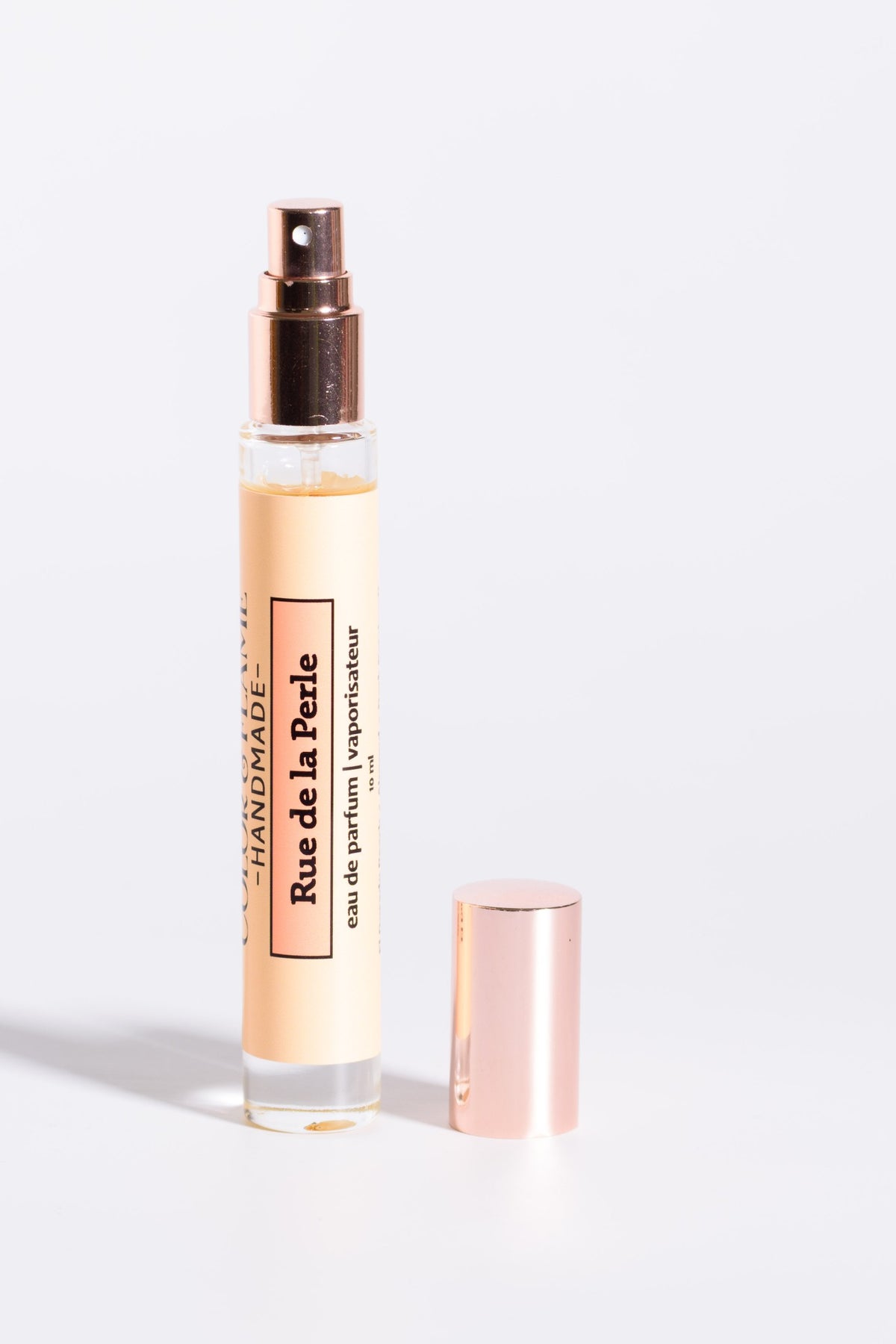 Color & Flame Handmade Rue de la Perle 10 ml perfume spray with cap removed to show the atomizer.
