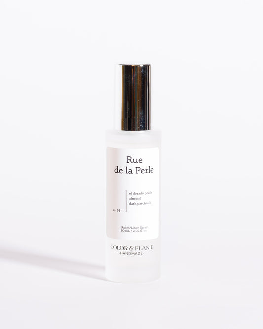 Color & Flame Handmade Rue de la Perle room and linen spray bottle with its silver cap attached.
