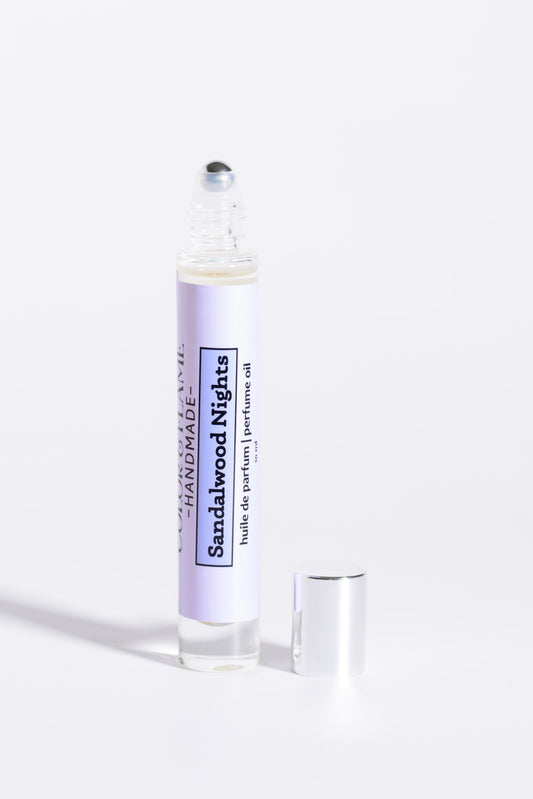 Color & Flame Handmade Sandalwood Nights 10 ml perfume oil with cap removed to show the rollerball.
