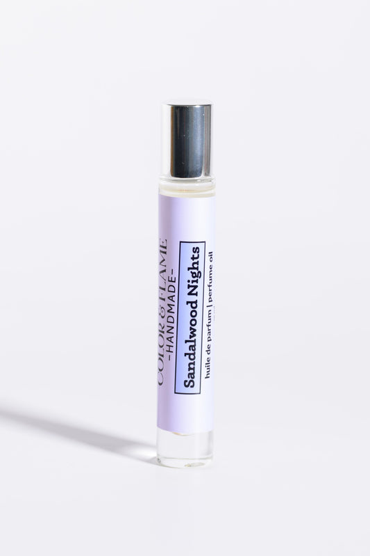 Color & Flame Handmade Sandalwood Nights 10 ml roll-on perfume oil with its silver cap attached.
