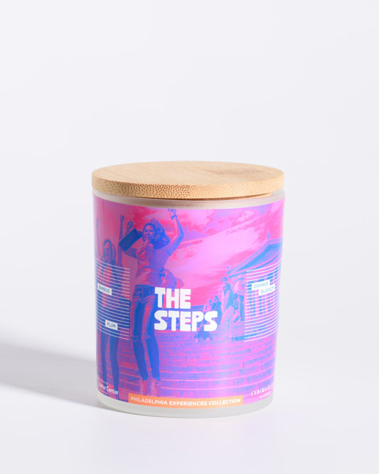 Color & Flame Handmade The Steps Philadelphia Experiences candle with its bamboo lid attached.
