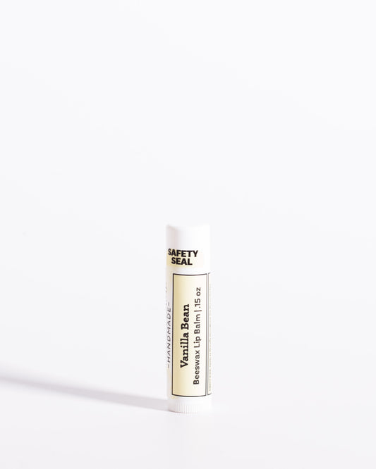 Color & Flame Handmade Vanilla Bean beeswax lip balm in a white tube with a cream label.